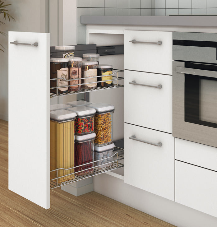 Kitchen cabinet with pull-out spice rack containing jars of various spices.