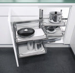 Pull-out kitchen drawer with utensils and cookware in a modern kitchen setting
