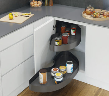 Corner kitchen cabinet with pull-out shelves containing jars and containers.