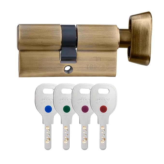 Bronze door lock cylinder with four keys on a white background