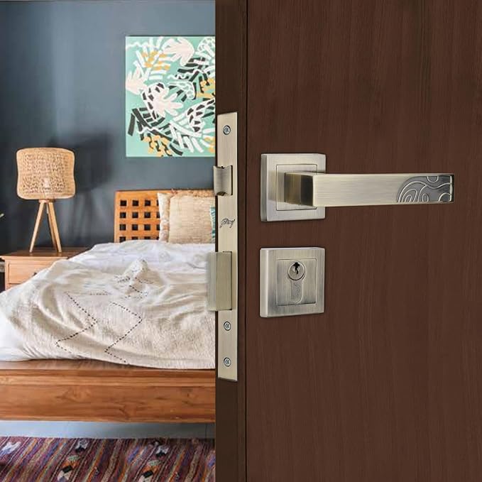 Wooden door with silver handle and lock in a bedroom setting