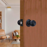 Wooden door with black door handles in a room with a couch and coffee table.