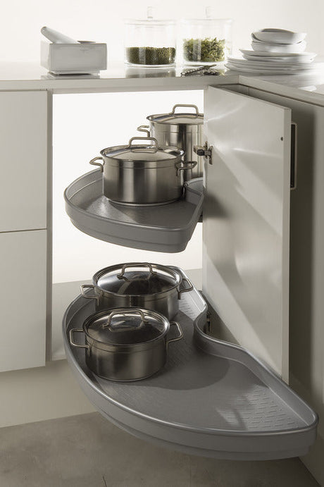 Corner kitchen cabinet with pull-out shelves holding pots and pans.