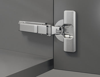 Metallic cabinet hinge on a gray cabinet door