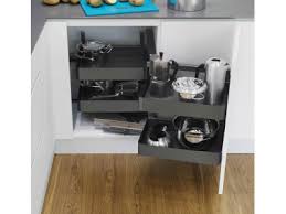 Open kitchen cabinet with various utensils and cookware on a wooden floor.