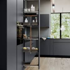 Modern kitchen with gray cabinets and a shelf with decorative items.