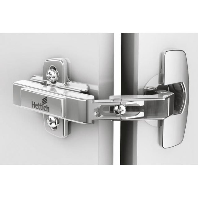 Close-up of a Hettich door hinge on a white background