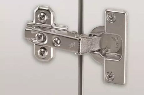 Close-up of a metallic hinge on a white background