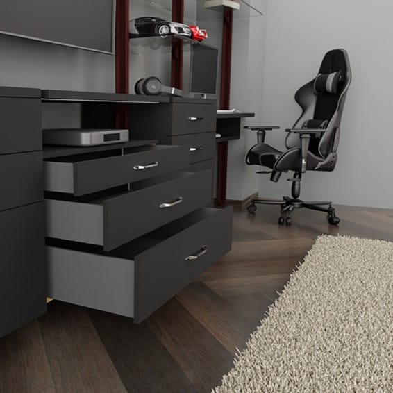 Open kitchen drawer with plates and jars inside, set against a dark cabinet and gray countertop.