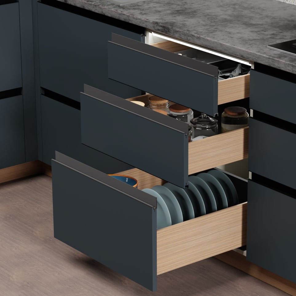 Open kitchen drawer with plates and jars inside, set against a dark cabinet and gray countertop.