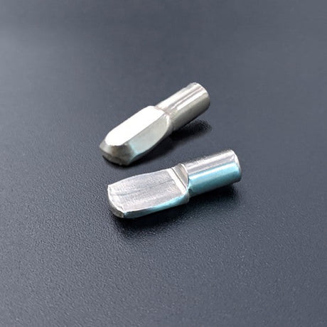 Two metallic drill bits on a dark gray background