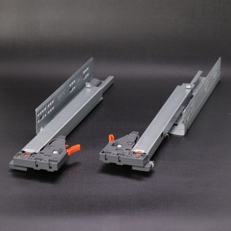 Two metal brackets with clamps on a dark background
