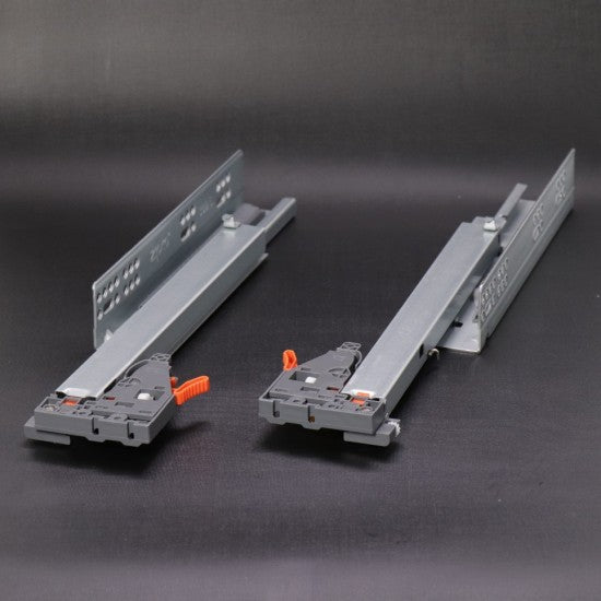 Two metal brackets with clamps on a dark background