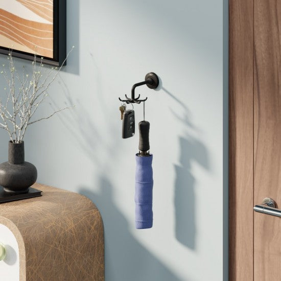 Wall-mounted coat rack with a blue umbrella holder and keys on a light gray wall.
