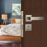 Wooden door with silver handle and lock in a bedroom setting