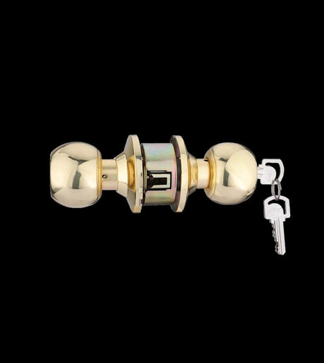 Gold door handle with key on a black background